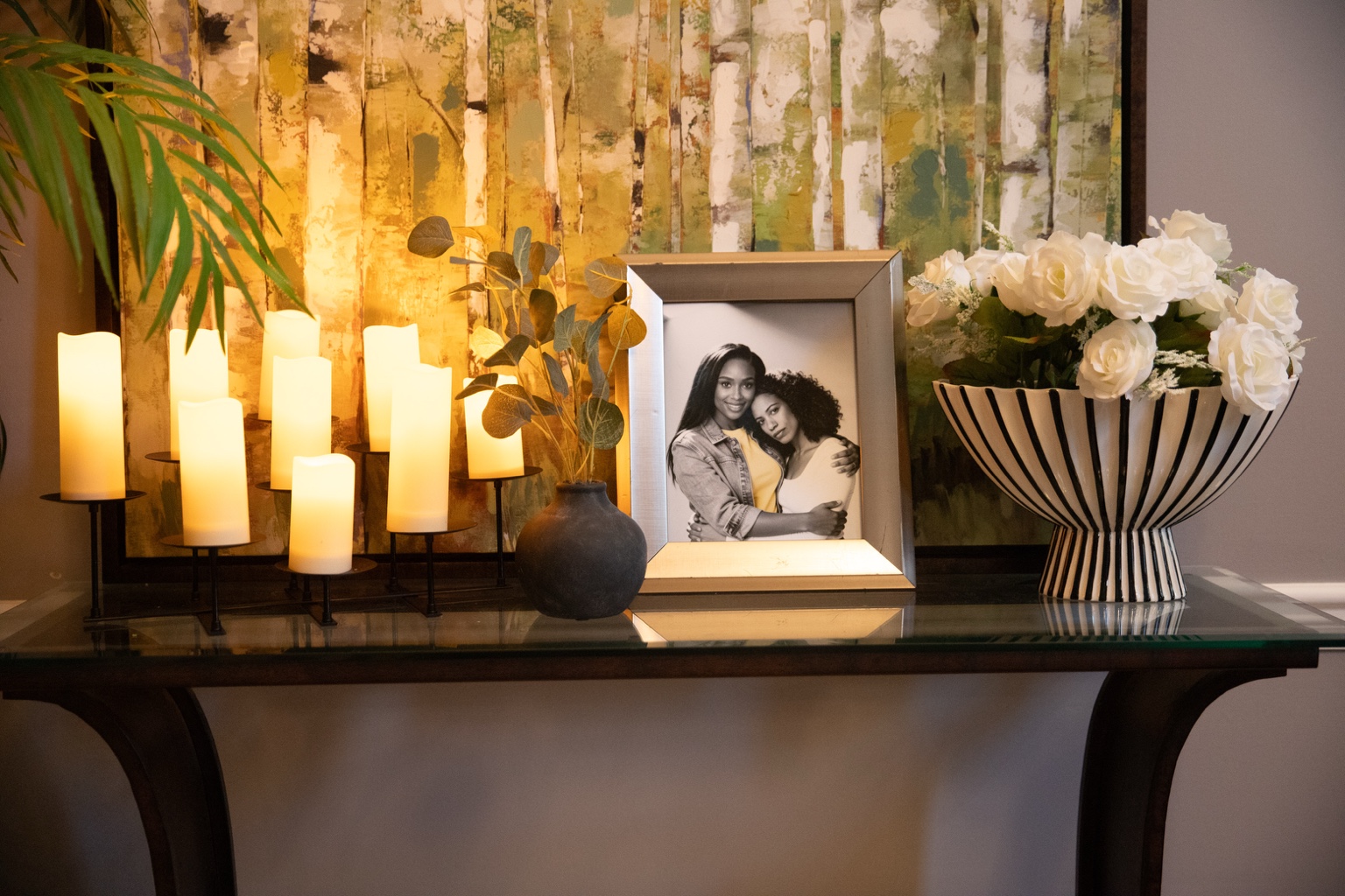 Framed family photo, flowers and candles arranged in a Black Coffee set