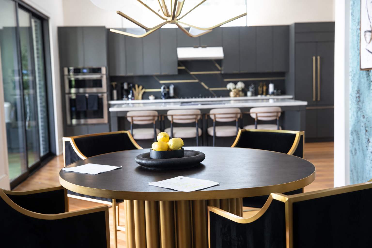 Black and gold dining set and kitchen, retouched to remove people