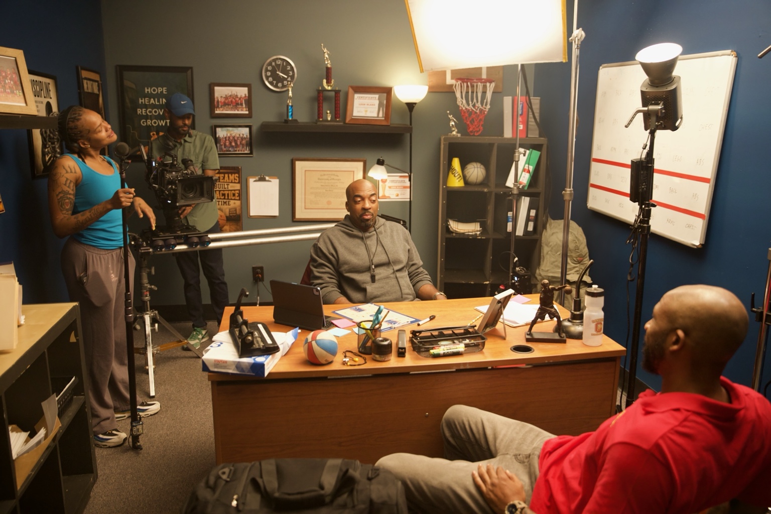 Office environment during filming with set dressing and camera crew