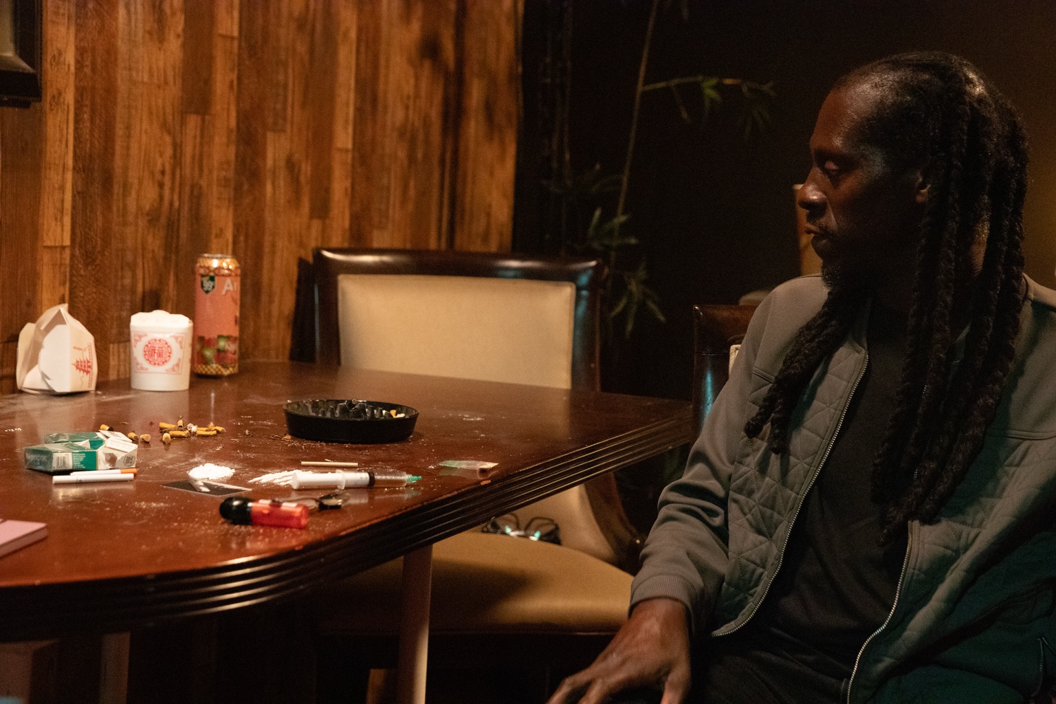 Dramatic table scene with story props and wood-paneled walls